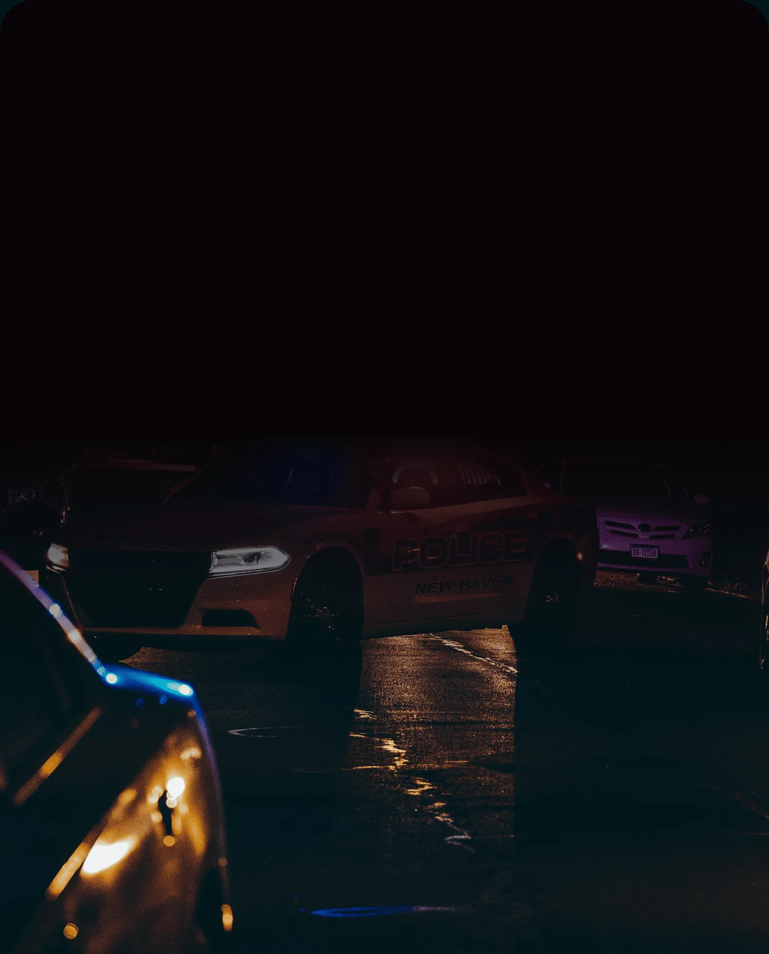 Police lights on a night street where OSINT helps fight crime