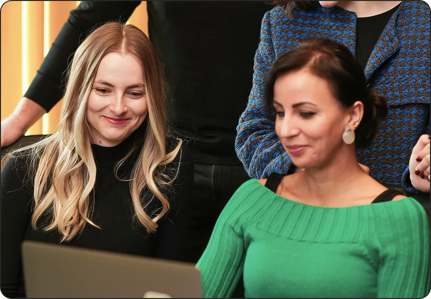 Two colleagues at a laptop checking personal data exposure online