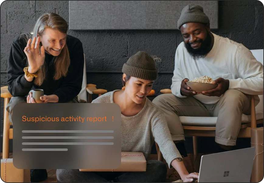 Friends reviewing a suspicious activity report on a laptop together