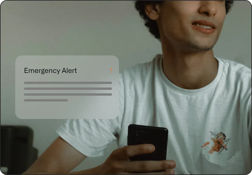 Young man receiving an emergency alert on his iPhone